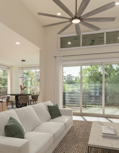 Modern open-concept living room and kitchen with neutral decor, large ceiling fan, marble fireplace, sliding glass doors, and natural light from multiple windows.