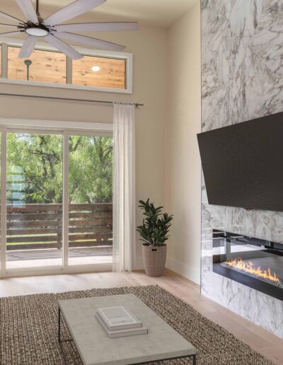Modern living room with a white couch, marble fireplace, wall-mounted TV, large windows with curtains, a potted plant, and a ceiling fan.